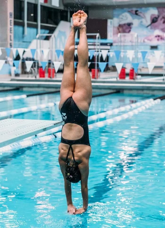 пловчиха прыгает в бассейн